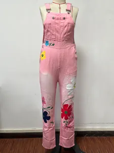 Full front view of women's pink denim overalls with colorful floral print details