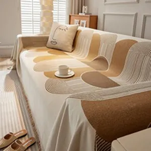 Detail of bohemian chenille sofa throw with geometric patterns and fringe edges