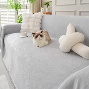Cozy lifestyle view of a gray chenille sofa cover blanket draped over a living room couch.