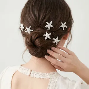 Macro detail of elegant rhinestone starfish hair pins elegantly styled in a bridal hair bun