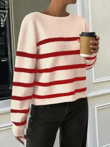 Close-up of a stylish pink and red striped knit sweater with soft texture and long sleeves