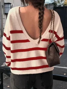 Detailed view showing the deep V-neck back design of a red and white striped knit sweater