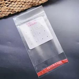 Detailed view of clear self-sealing plastic bag with a white 12-hole earring display card.
