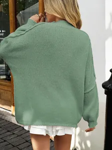 Detailed back view of a sage green oversized chunky knit sweater with textured weave