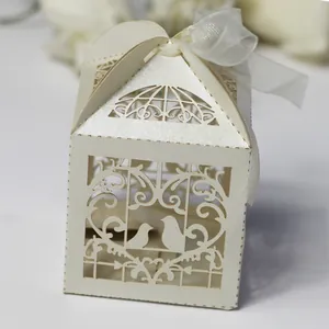 Elegant laser-cut bird wedding candy box with pearlescent paper and white ribbon tie