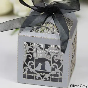 Silver grey laser-cut favor box with bird motif and black ribbon bow for weddings