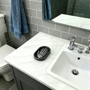 Decorative gothic resin soap dish with skeleton hand design on marble bathroom vanity