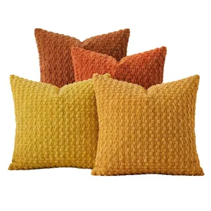 Set of solid color popcorn textured pillow covers in mustard yellow and terracotta