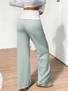 Rear view showing the fit and green striped pattern of high-waisted wide-leg lounge pants