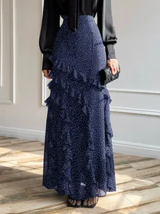 Detailed view of navy blue polka dot ruffle maxi skirt featuring elegant layered tiers.