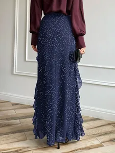 Back view detail of navy blue polka dot long skirt with elegant side ruffles