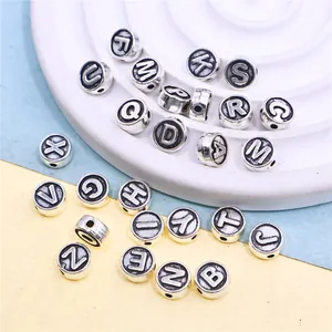 Detailed macro shot of vintage silver alloy alphabet beads for DIY jewelry making