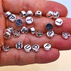 Macro view of assorted silver alloy alphabet beads for DIY personalized jewelry making
