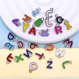 Close-up view of a 26-piece set of colorful enamel alphabet letter charms for DIY jewelry.