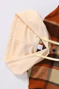 Close-up of men's hooded plaid shirt collar with 100% polyester label details