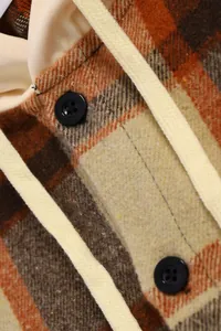 Close-up detail of heavy plaid hoodie shirt showing flannel fabric and black buttons
