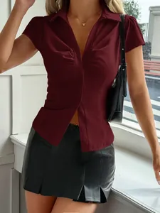 Détail d'une chemise bordeaux style Y2K avec une minijupe plissée en similicuir noir chic