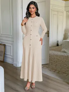 Elegant beige long-sleeved textured maxi dress with gold buttons for formal occasions