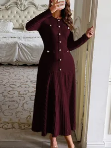 Detail of an elegant burgundy knitted midi dress with gold decorative buttons.