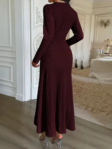 Elegant burgundy long-sleeved maxi dress with textured fabric detail back view
