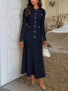 Elegant navy blue long-sleeve textured knit midi dress featuring decorative gold buttons
