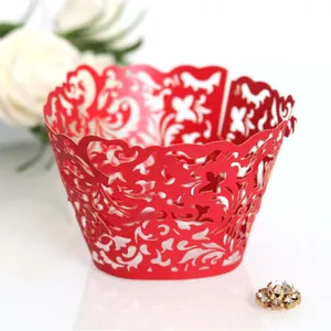 Red laser-cut cupcake wrappers with intricate floral lace for wedding party decorations