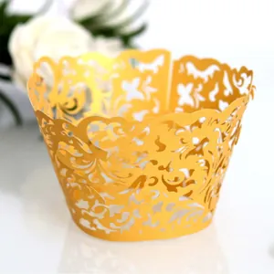 Elegant golden pearlescent laser-cut cupcake wrappers with floral hollow patterns for weddings