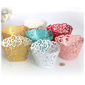 Elegant laser-cut cupcake wrappers with intricate floral patterns for weddings and parties.