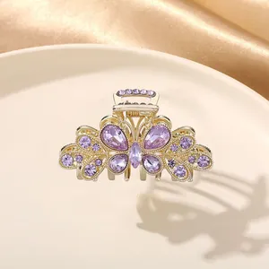 Elegant butterfly hair claw clip featuring purple rhinestones and a premium gold finish