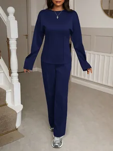 Full view of a women's navy blue long-sleeve top and trousers two-piece outfit set.