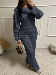 Modern two-piece lounge set in dark grey featuring long sleeve top and wide leg trousers