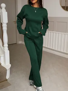 Full view of elegant dark green two-piece lounge set worn by a model indoors.