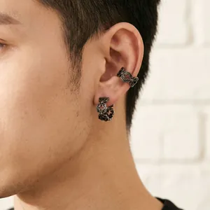 Male model wearing vintage hollow cross ear cuff and earring set in trendy punk style
