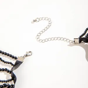 Detail view of silver lobster clasp and extender chain on a black gothic choker