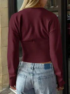 Detailed back view of women's burgundy knit sweater featuring a stylish ribbed waist design