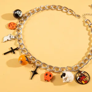 Detailed view of Halloween necklace with pumpkin and ghost charms on silver chain