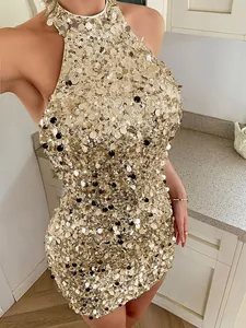 Detailed shot of sparkling gold sequins on an elegant halter neck mini evening dress