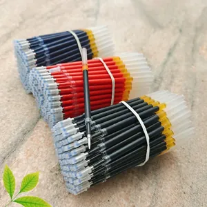 Detailed macro view of three-color ballpoint pen refills in black, red, and blue ink