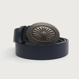 Close-up of a vintage navy leather belt featuring an intricate engraved alloy buckle