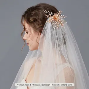 Detailed side view of a French style white bridal veil with pearl flower accessory