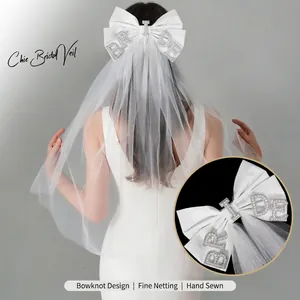 Elegant French bridal veil featuring a white ribbon bow with pearl BRIDE letters