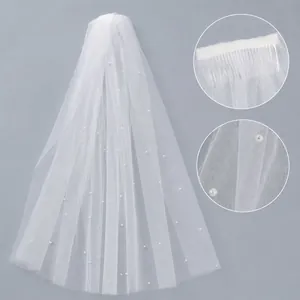 Elegant white tulle bridal wedding veil featuring delicate pearls and a hair comb