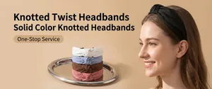 Close-up of model wearing black knotted twist headband and colorful options on silver tray