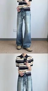 Model wearing vintage light wash wide-leg denim jeans with a striped polo knit shirt