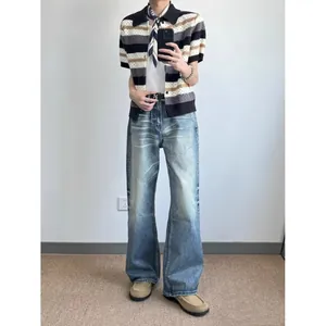Vintage American style men's loose wide-leg denim jeans with a faded wash finish