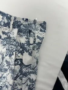 Close-up detail of high-waisted pants featuring blue toile de jouy leopard print