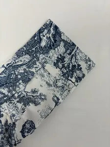 Detailed macro view of navy blue toile de jouy print on a white shirt buttoned cuff