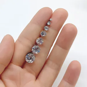 Set of seven stainless steel six-prong cubic zirconia stud earrings shown on hand