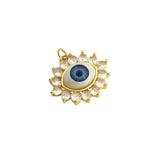 Elegant 18k gold plated evil eye pendant featuring a blue pupil and sparkling clear stones