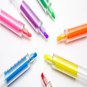 Macro detail of colorful syringe-shaped highlighters showing vibrant ink colors and tips